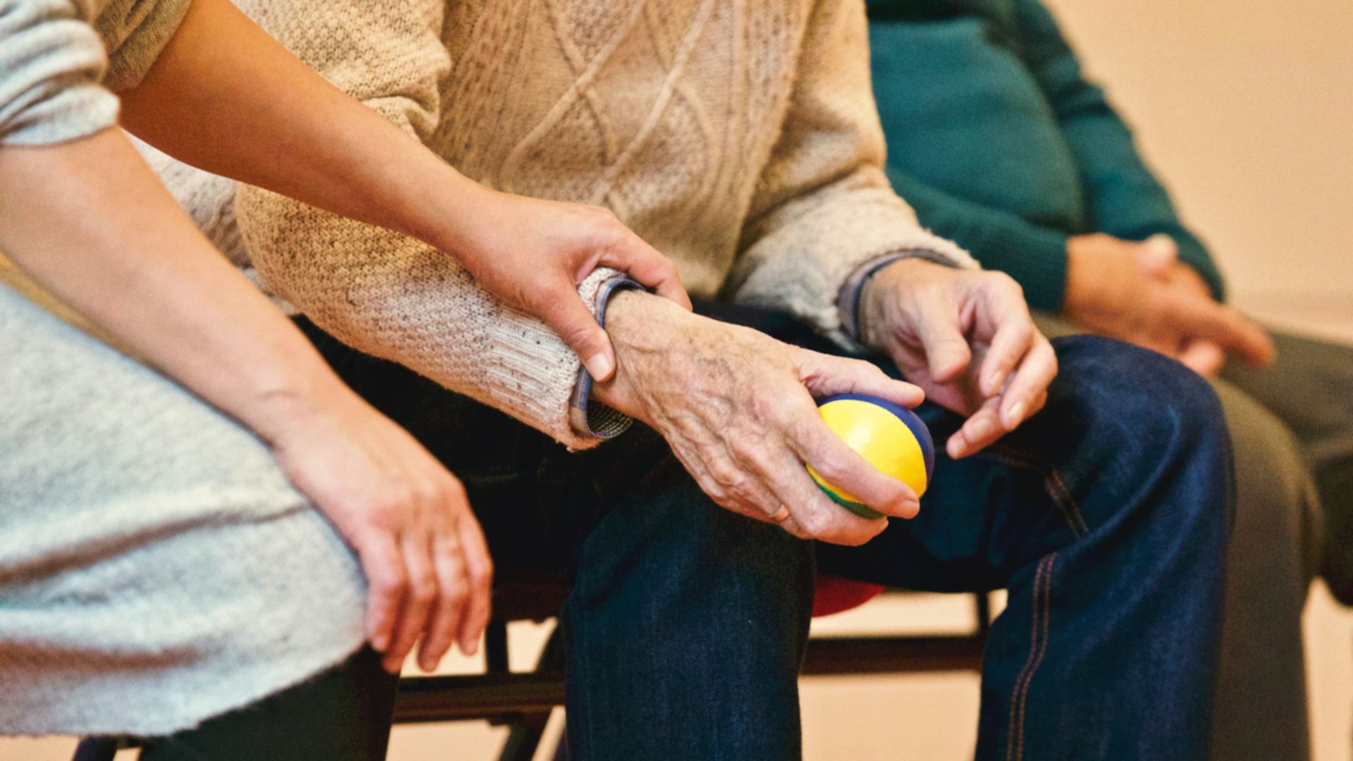 Elderly hands being held by another