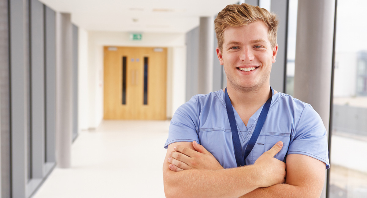 photo of male health care student smiling at camera